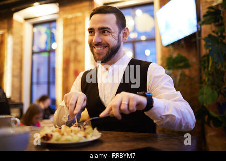 Businessman Eating Food n Restaurant Stock Photo