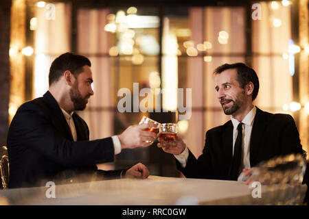 Celebrating Deal in Restaurant Stock Photo