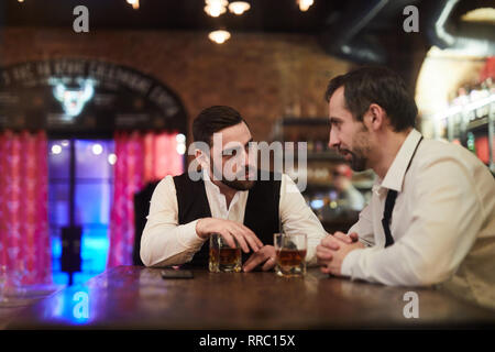 Late Night Chatting in Bar Stock Photo