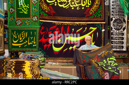 TEHRAN, IRAN - MAY 22, 2017: Seller selling carpets in local shop at Tehran Grand Bazaar. Iran Stock Photo