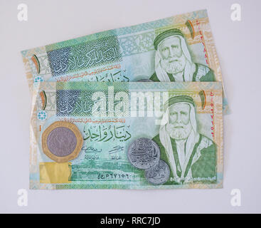 Foreign money banknotes; Jordanian 1 Dinar notes with Sharif Hussein bin Ali, half Dinar hexagonal coin Stock Photo