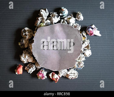 Help : words printed on newspaper cutting on top of a pile of crumbled papers Stock Photo