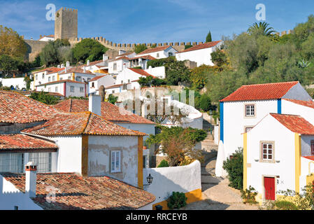 Charming medieval village with  white washed houses and castle on top Stock Photo