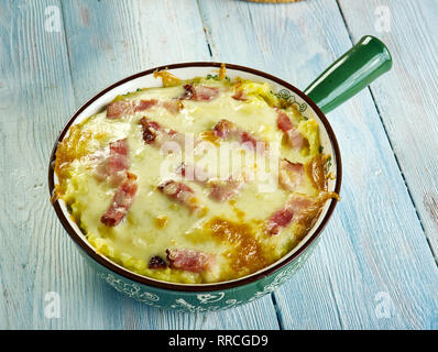 Cheesy Ham and Hash Brown Casserole,  large bowl, mix together hash browns, ham, cream of potato soup, sour cream, and cheddar cheese Stock Photo