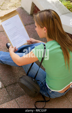 teenage girl reading her exam results Stock Photo