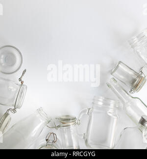 many different empty glass bottles lying on a white background Stock Photo
