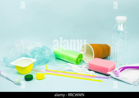 Plastic waste concept: varitety of single use objects that get thrown out every day. Plastic bottle, hygiene items and plastic package depicting ecolo Stock Photo