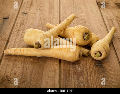Parsnip or pastinaca sativa roots on rustic wood background Stock Photo