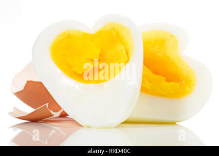 Soft boiled Egg in Heart Shape on white Backround Stock Photo