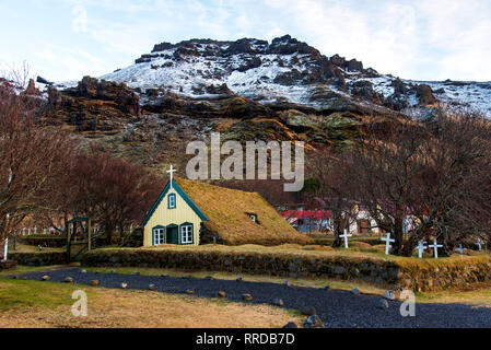 Hofskirkja yellow turf church in town of Hof in South Iceland Stock Photo