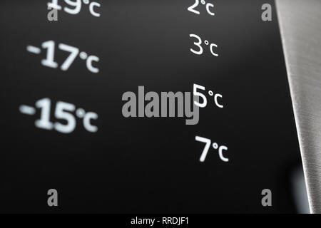 Closeup of modern steel colored fridge and freezer control panel. Internet of things abstract concept. Stock Photo