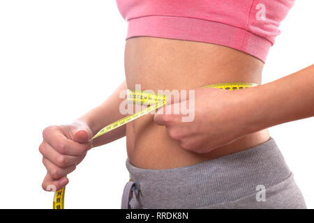 sport, fitness and diet concept, trained belly with measuring tape Stock Photo