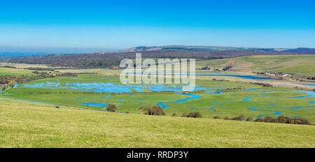 Walk to Cuckmere Haven beach near Seaford, East Sussex, England. South Downs National park. View of blue waters of the river, birds, long photo banner, selective focus Stock Photo