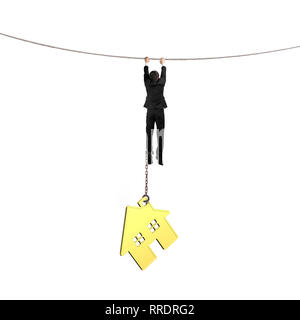 Businessman shackled by gold house hanging on the rope, isolated on white background. Stock Photo