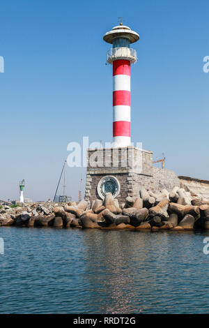 Burgas, Bulgaria - July 22, 2014: Red and white striped lighthouse tower in the port of Burgas, Black Sea