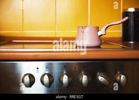 One coffee pot on kitchen stove, ordinary lifestyle scene. Stock Photo