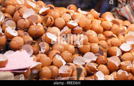 natural food ingredient, broken brown chicken egg shells in front of bakery shop in food market stall. Nutrition, Poultry Egg, Food, Wet Waste, Natura Stock Photo