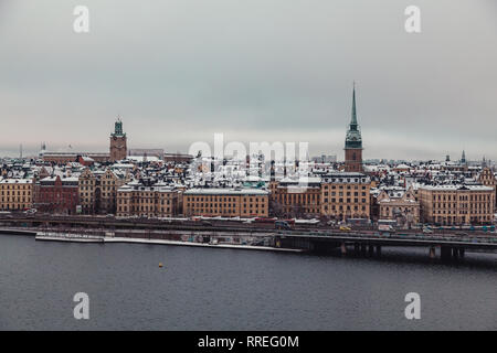 Editorial 12.17.2019 Stockholm Sweden, Old town behind the bridge on a winter day with snow on the rooftops Stock Photo