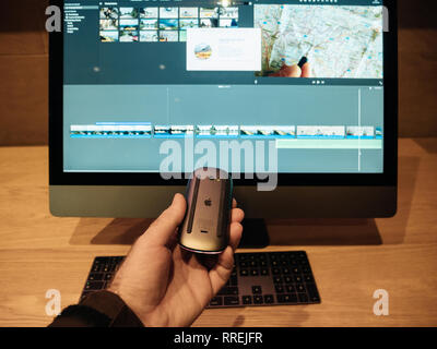 PARIS, FRANCE - JAN 10, 2018: New Apple iMac Pro workstation computer in Apple Store - the Space Gray workstation featuring Intel Xeon CPU and Radeon Vega GPU man holding Magic mouse Stock Photo