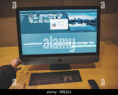 PARIS, FRANCE - JAN 10, 2018: Customer hand holding the new New Apple iMac Pro workstation computer in Apple Store - the Space Gray workstation featuring Intel Xeon CPU and Radeon Vega GPU Stock Photo