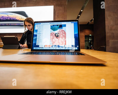 PARIS, FRANCE - NOV 8, 2018: new Apple MacBook Air thin laptop featuring Retina screen and new CPU - Apple Store view young woman testing as well the laptop Stock Photo