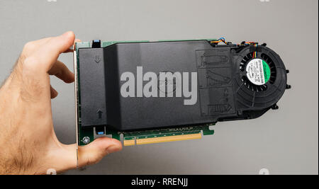 Paris, France - Oct 14, 201 : Man IT guy holding against gray background a powerful Dell Ultra-Speed Drive Quad NVMe M.2 PCIe x16 Card for 4 nvme drives Stock Photo