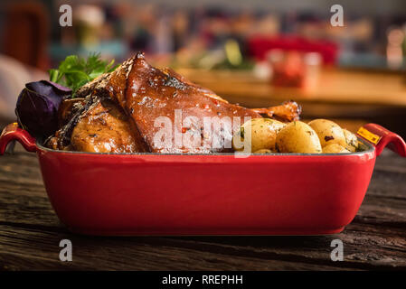 Close up roast pork knuckle served with boiled potatoes in tray Stock Photo