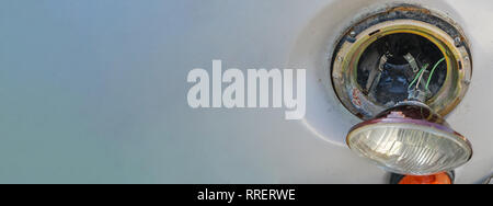 Broken car headlight hanging on the wires Stock Photo - Alamy