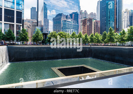 New York City, USA - July 27, 2018: National September 11 Memorial and Museum, also known as the 9/11 Memorial and Museum or Ground Zero, with people  Stock Photo