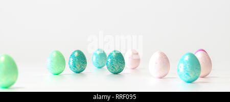 Blue, Red, green, cyan and pink colored Easter eggs balanced on its blunt end on white background with wide copy space Stock Photo