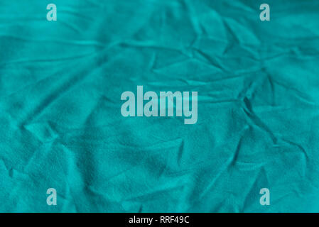 blue color creased textile selective focus background Stock Photo