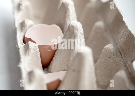 Brocken egg in the package on the table Stock Photo