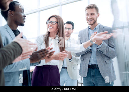 Multi-ethnic business team applauding to speaker after presentation on new project Stock Photo