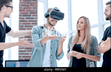 Positive colleagues testing virtual reality glasses Stock Photo