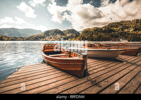 Traditional wooden boats Pletna on the backgorund of Church on the Island on Lake Bled, Slovenia. Europe. Stock Photo