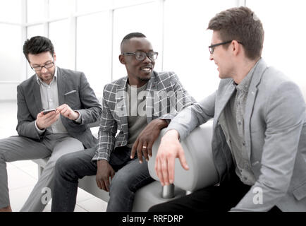 group of employees sitting in the office lobby. Stock Photo