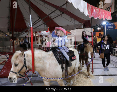 Houston, USA. 25th Feb, 2019. Girls ride ponies on the opening day of the Houston Livestock Show and Rodeo in Houston, Texas, the United States, on Feb. 25, 2019. The Houston Livestock Show and Rodeo, also called RodeoHouston or abbreviated HLSR, is the largest livestock exhibition and rodeo in the world. It includes one of the richest regular-season professional rodeo events. Credit: Yi-Chin Lee/Xinhua/Alamy Live News Stock Photo