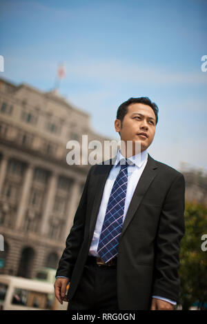 Businessman standing in front of building in the city. Stock Photo