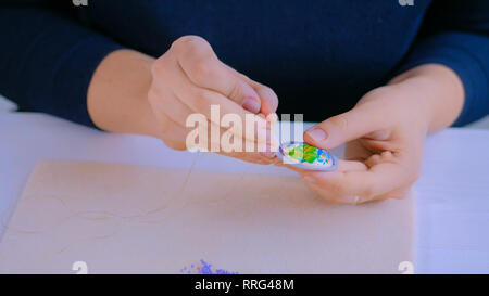 Designer making handmade brooch Stock Photo