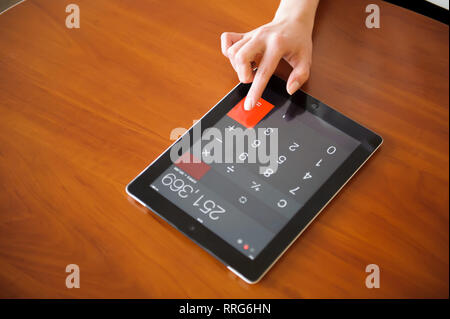 Human Hand and Digital Tablet. calculator bill Stock Photo