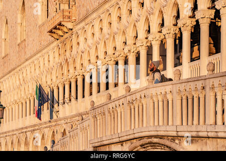 A man looks out from the bridge in front of the Doge's Palace in Venice at sunrise. From a series of travel photos in Italy. Photo date: Tuesday, Febr