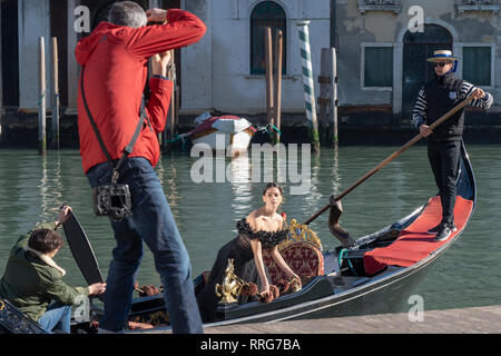 A model having her photo taken on a gondola in Venice. From a series of travel photos in Italy. Photo date: Tuesday, February 12, 2019. Photo: Roger G Stock Photo