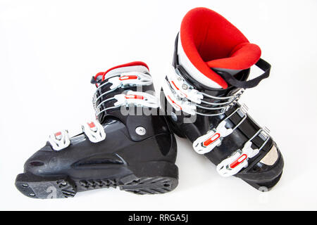 A pair of red and black alpine ski boots isolated on white background. Stock Photo