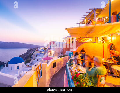 View of restaurant in Oia village overlooking the sea at dusk, Santorini, Cyclades, Aegean Islands, Greek Islands, Greece, Europe Stock Photo