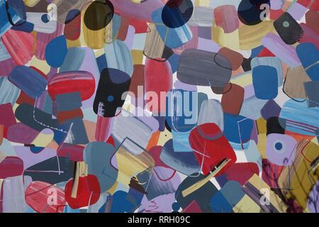 A colorful mural of circular patterns on the side of a building. Stock Photo