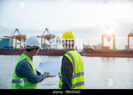 Two engineers are checking the accuracy of the product. Stock Photo