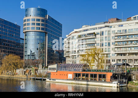 Berlin, Germany - February 14, 2019: River Spree embankment Bundesratufer and the new area Spree-Bogen with the building of the business center Stock Photo