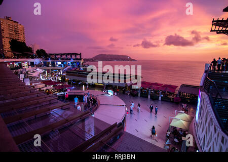 Lima, Peru - February 22 2019: View of Larcomar shopping mall in Miraflores district during a scenic sunset, Chorrillos and Morro solar on the backgro Stock Photo