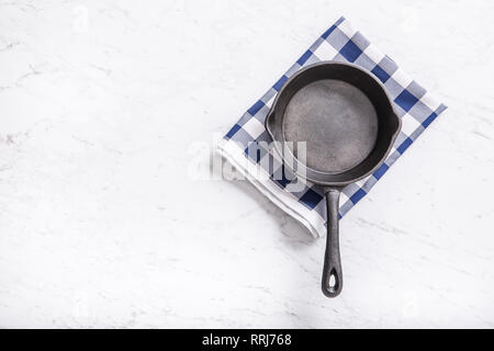 Empty pan on marble table with blue tablecloth - top of view. Stock Photo