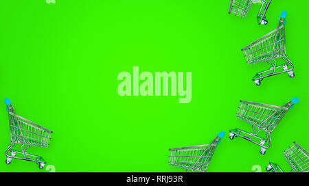 Miniature shopping carts isolated on green background Stock Photo
